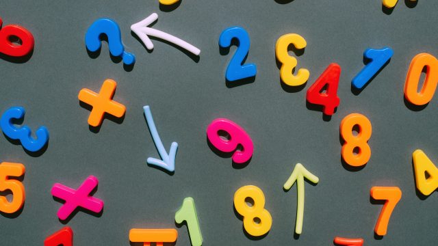 Multicolored numbers on a black background. Education. Mathematics. Finance. Economy. Money. Математика: факты о счёте, уравнениях и печально известных нерешённых задачах